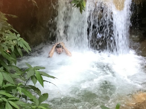 cooling off in a jungle waterfall